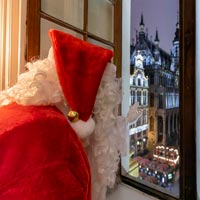 Santa Claus at the window of Le Roy d'Espagne at Christmas Fairies