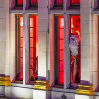Santa Claus at the window of Le Roy d'Espagne, waving to people on the Grand-Place, at Christmas Fairies