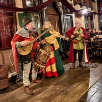 Troubadour and minstrel atmosphere at a medieval dinner.